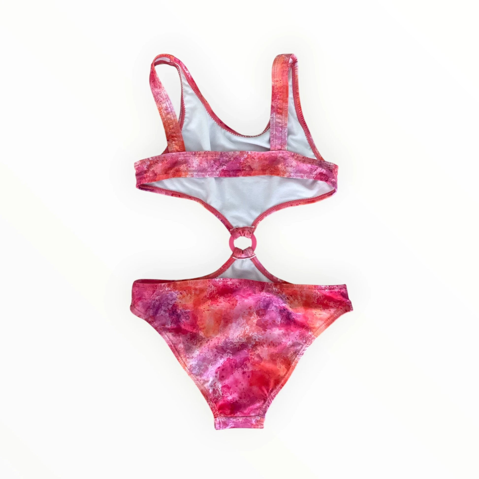 Pierrot Outlet dames monokini met roze en oranje aquarelprint, cut-out design en centrale ring voor een zomerse look.
