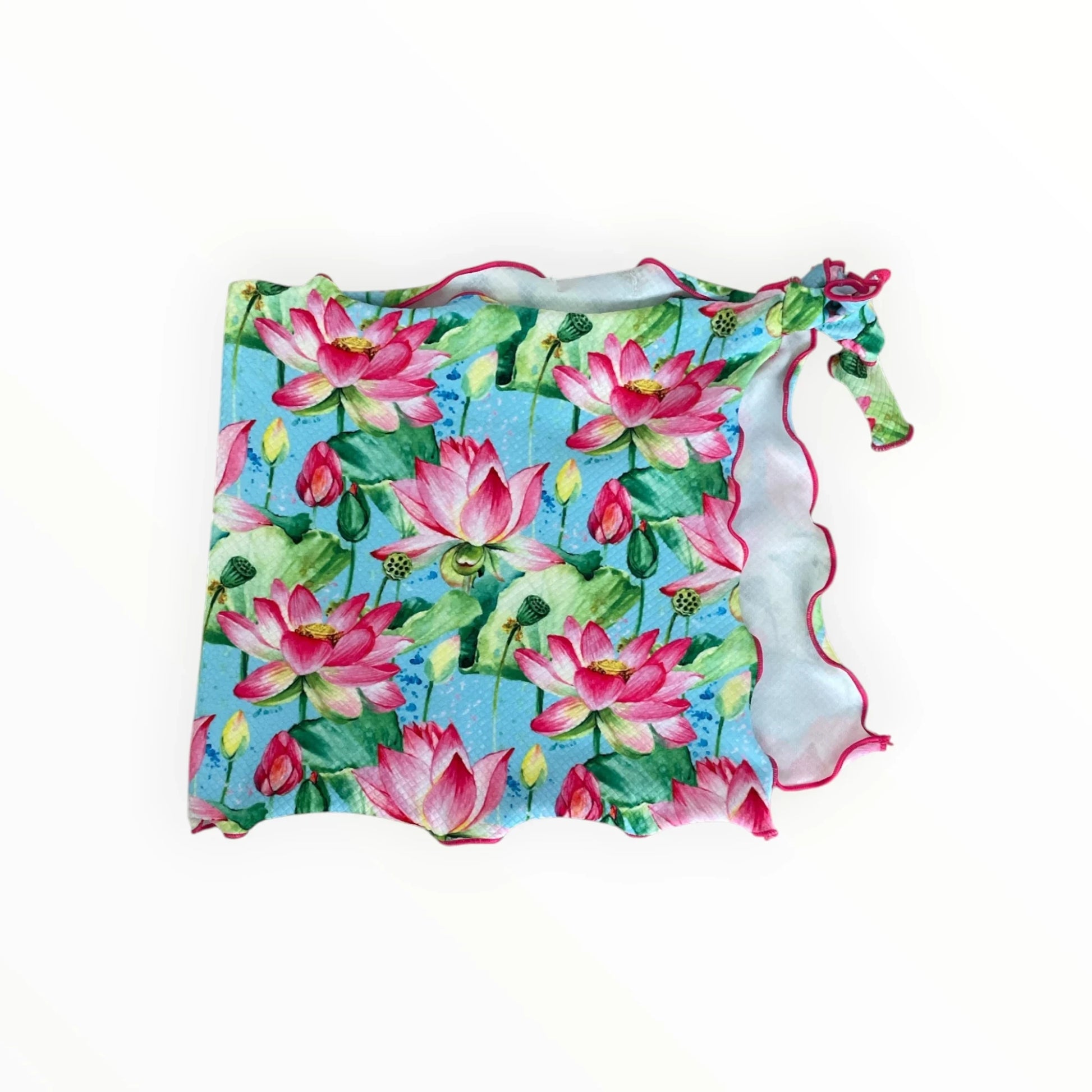 Pierrot Outlet dames sarong met roze lotusbloemen, groene bladeren en een golvende roze rand op een blauwe achtergrond.
