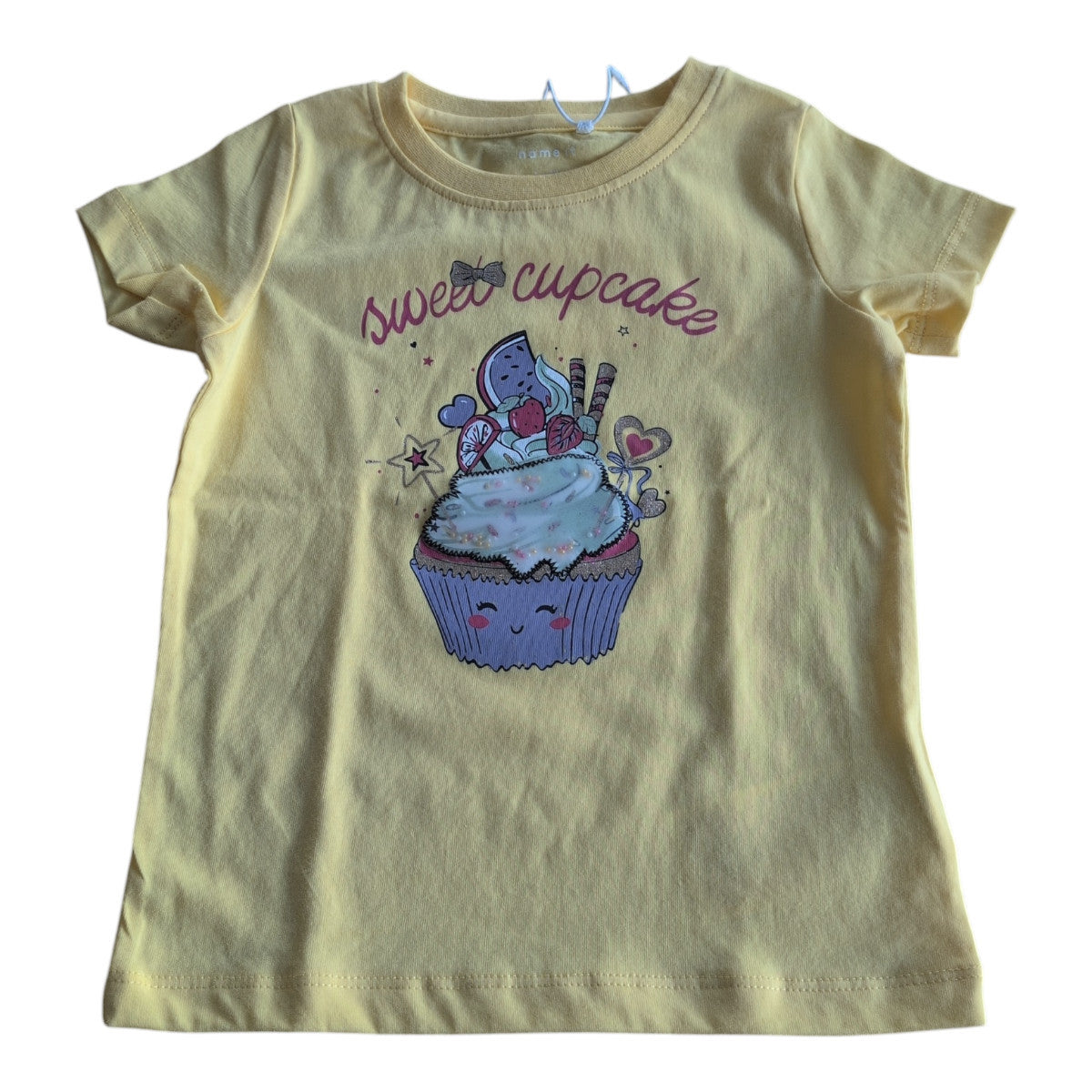 Pierrot Outlet meisjes T-shirt met korte mouwen in geel katoen, met een vrolijke cupcake print en de tekst 'sweet cupcake'.