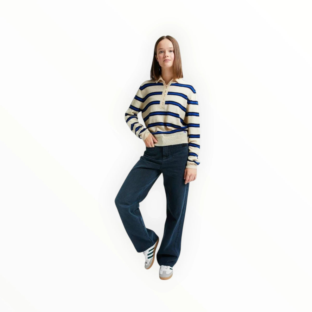Model draagt een Pierrot Outlet gestreept gebreid shirt in beige met blauwe en zwarte strepen en een knoopsluiting.