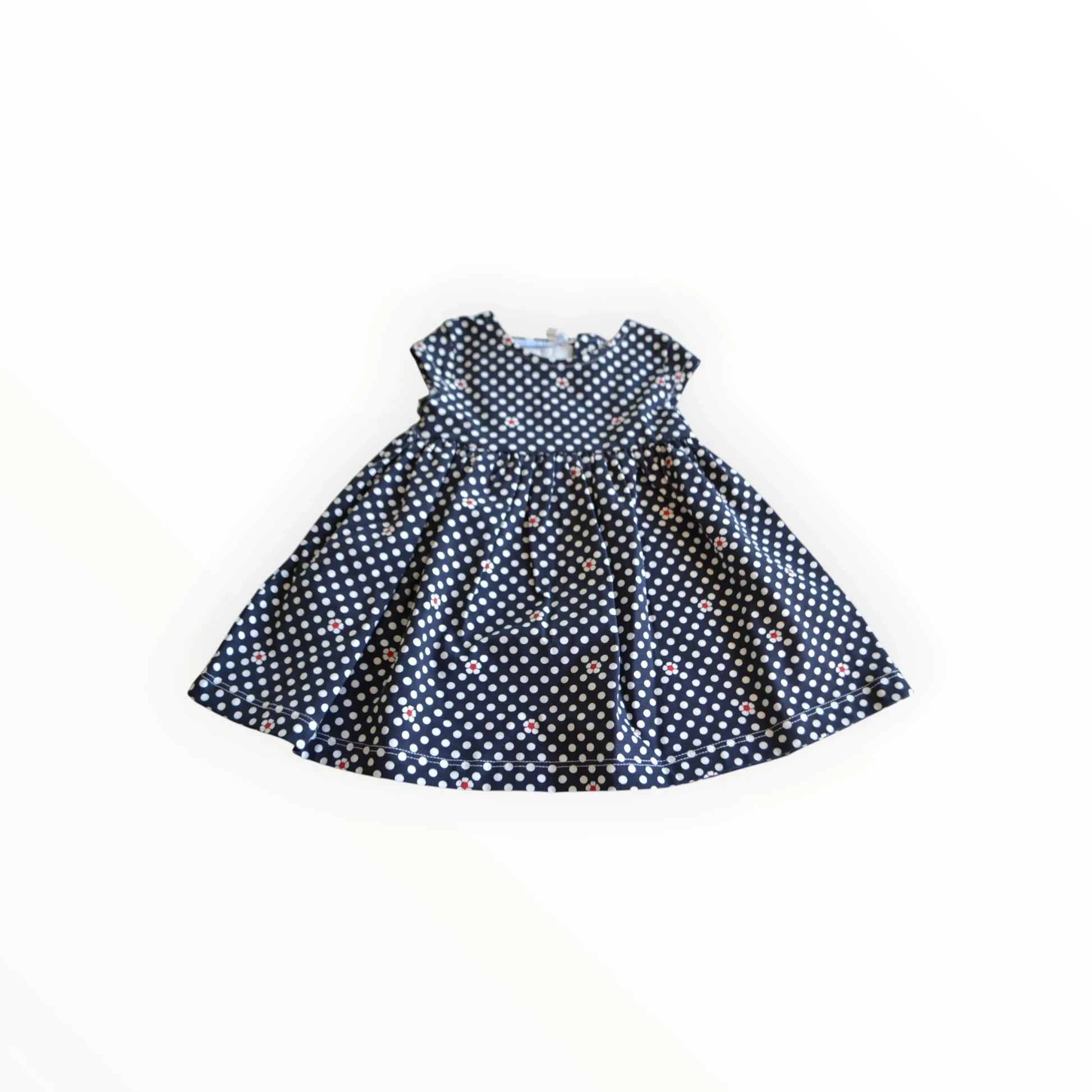 Pierrot Outlet marineblauwe babyjurk met witte polkadots en rode hartjes, korte mouwen en wijde rok.