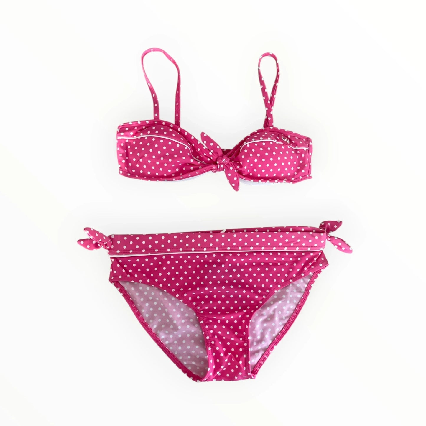 Pierrot Outlet roze bikini voor meisjes met wit stippenpatroon, strikdetails en verstelbare bandjes.