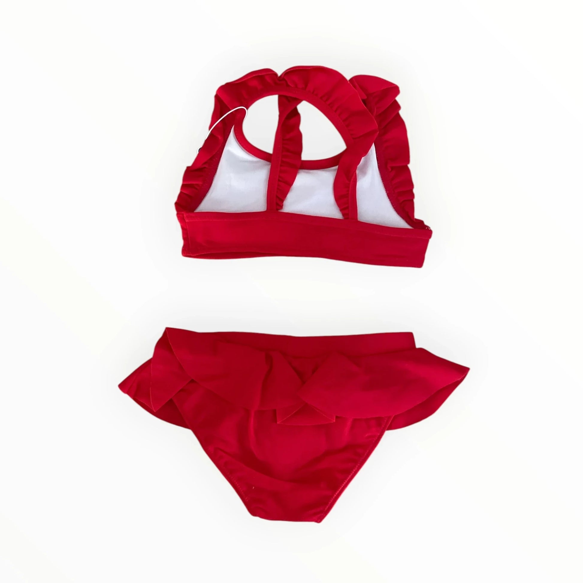 Pierrot Outlet rode tweedelige bikini voor kinderen met ruches en gekruiste bandjes op de rug.