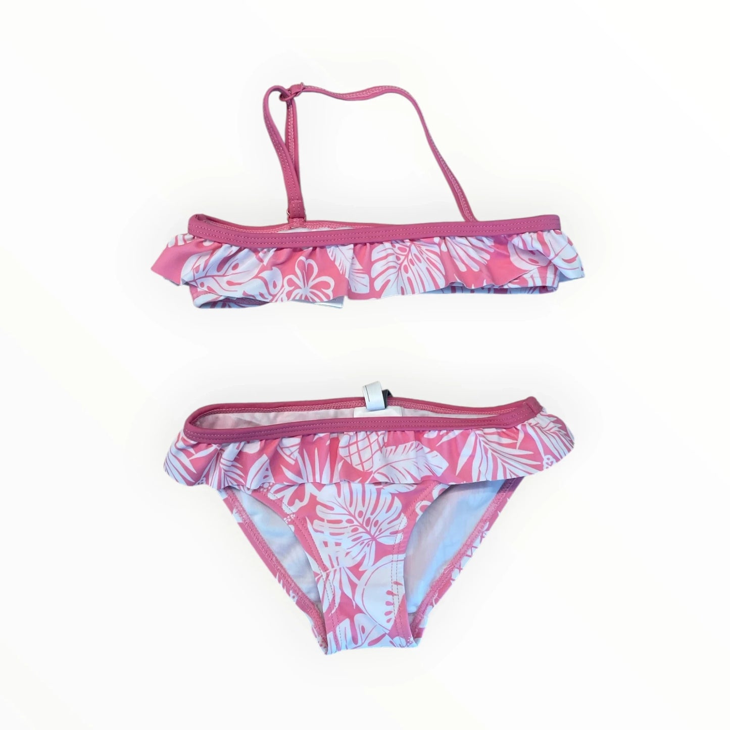 Pierrot Outlet roze bikini voor kinderen met tropische print, ruches en comfortabele pasvorm voor strand en zwembad.