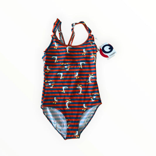 Pierrot Outlet WOODY meisjes badpak met vogelprint, oranje-blauwe strepen, ruches en gekruiste rugbandjes.