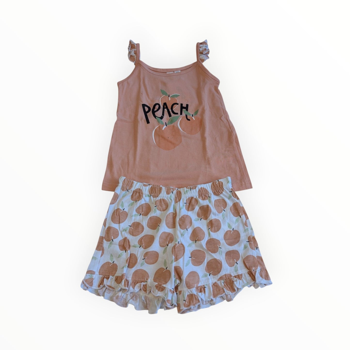 Pierrot Outlet zomerse pyjamaset voor kinderen met roze hemdje met perzikopdruk en bijpassende shorts met ruches.
